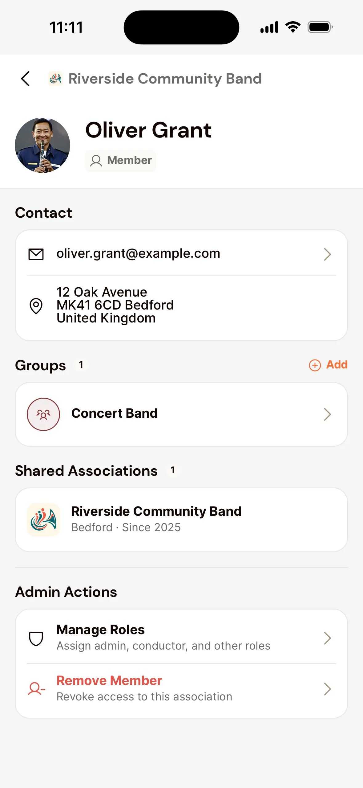 A member's page in the app for an admin: Contact, under Groups the Concert Band with Add on the right, and under Admin Actions Manage Roles and Remove Member.