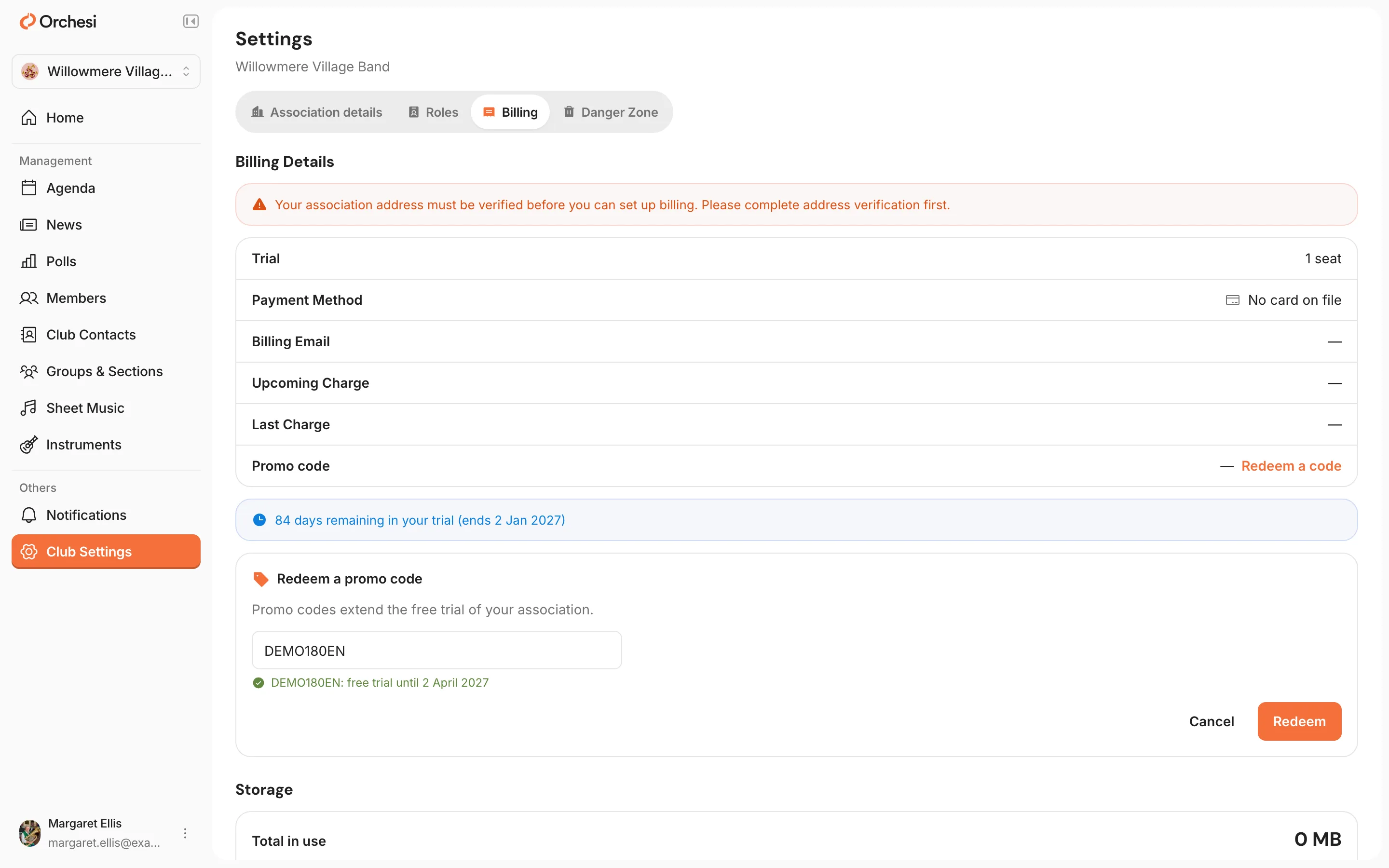 The settings of an association that isn't verified yet, Billing tab: at the top the notice that the address must be verified first; Redeem a code next to Promo code is chosen; under Redeem a promo code the code DEMO180EN with the date the free trial would then run until below it, and the Cancel and Redeem buttons.